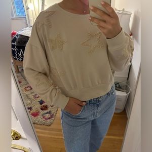 Tan sweatshirt with terry cloth stars.